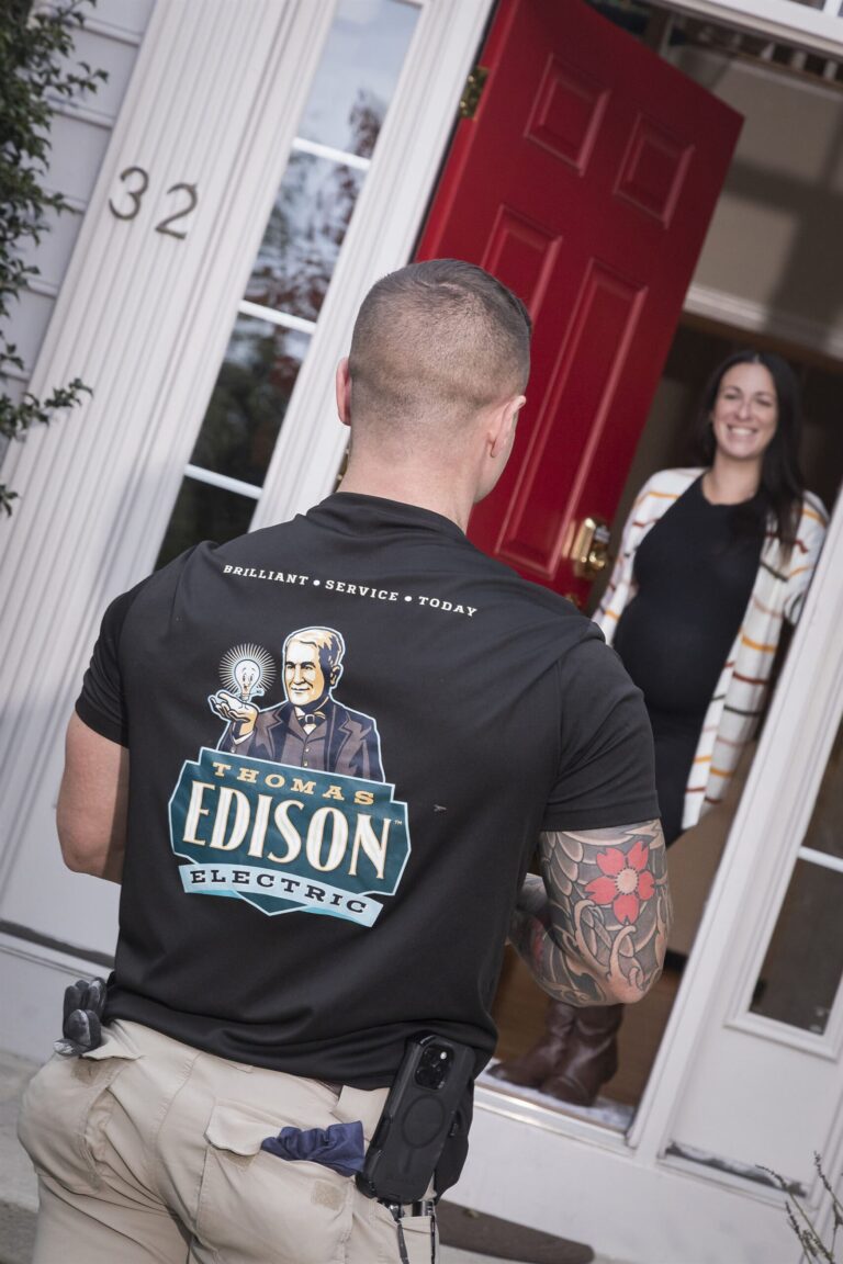 A Thomas Edison Electric electrician arriving at a customer's front door for a scheduled visit.