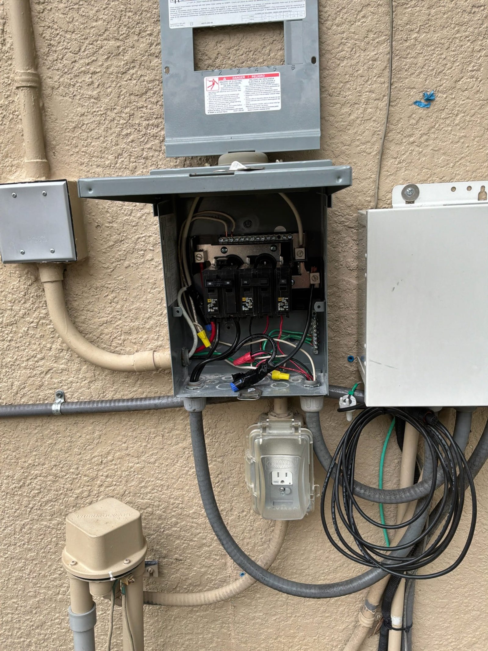 Exterior disconnect and GFCI-protected outlet installed during the safety upgrade