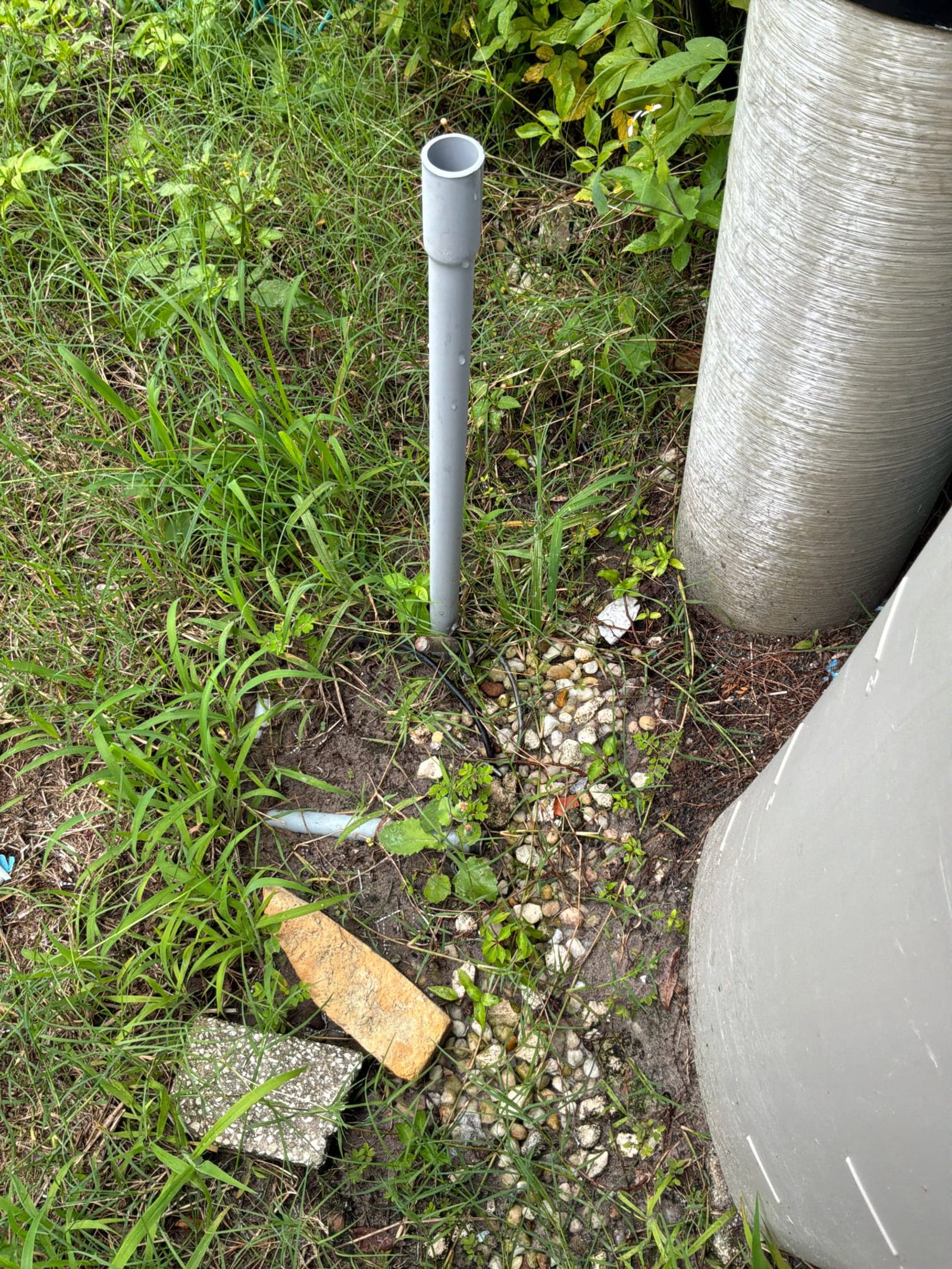Single ground rod in gravel bed adjacent to metal conduit with no supplemental electrode visible.