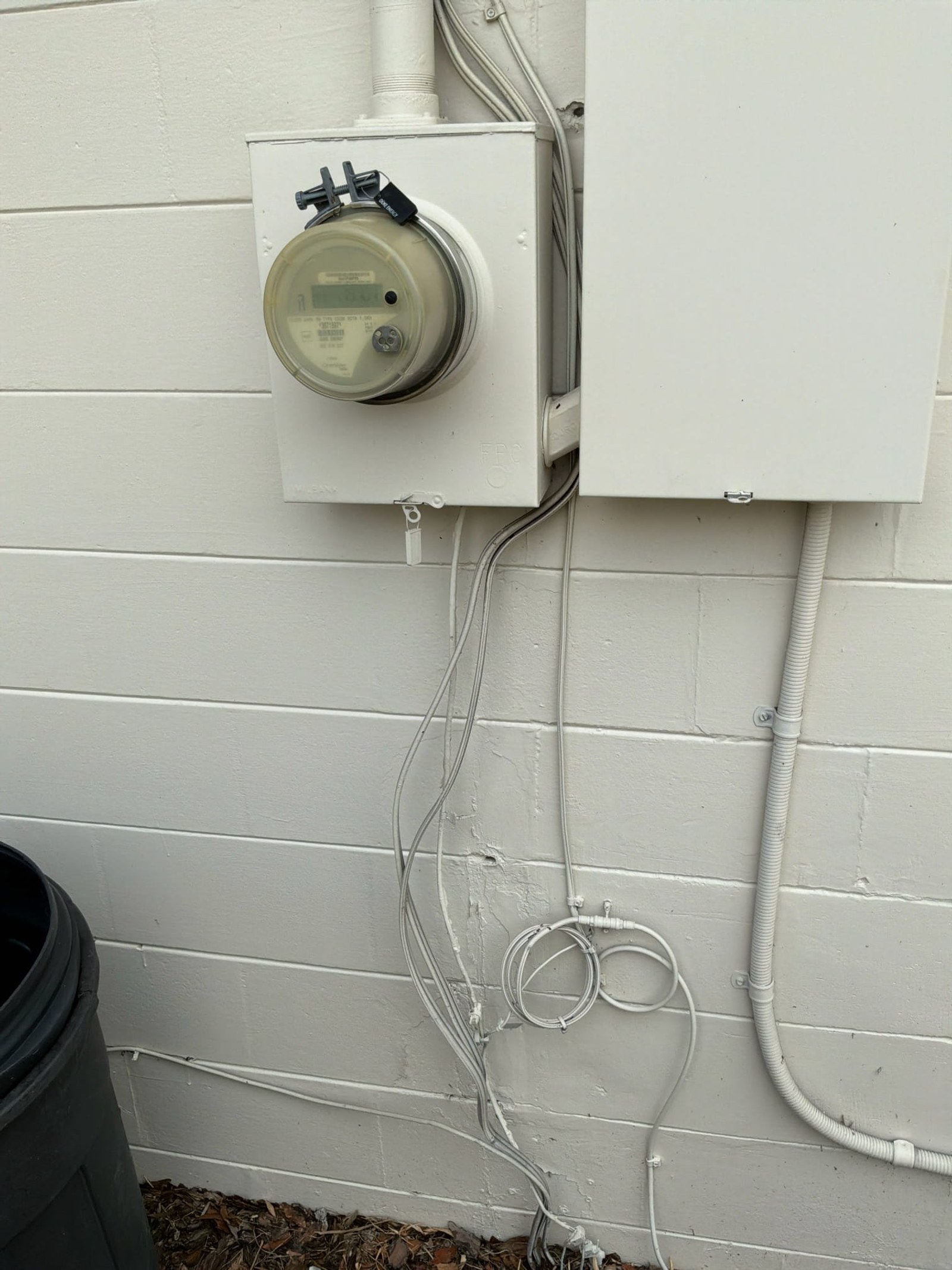 Exterior meter can showing no visible ground rod installation and exposed conduit runs.