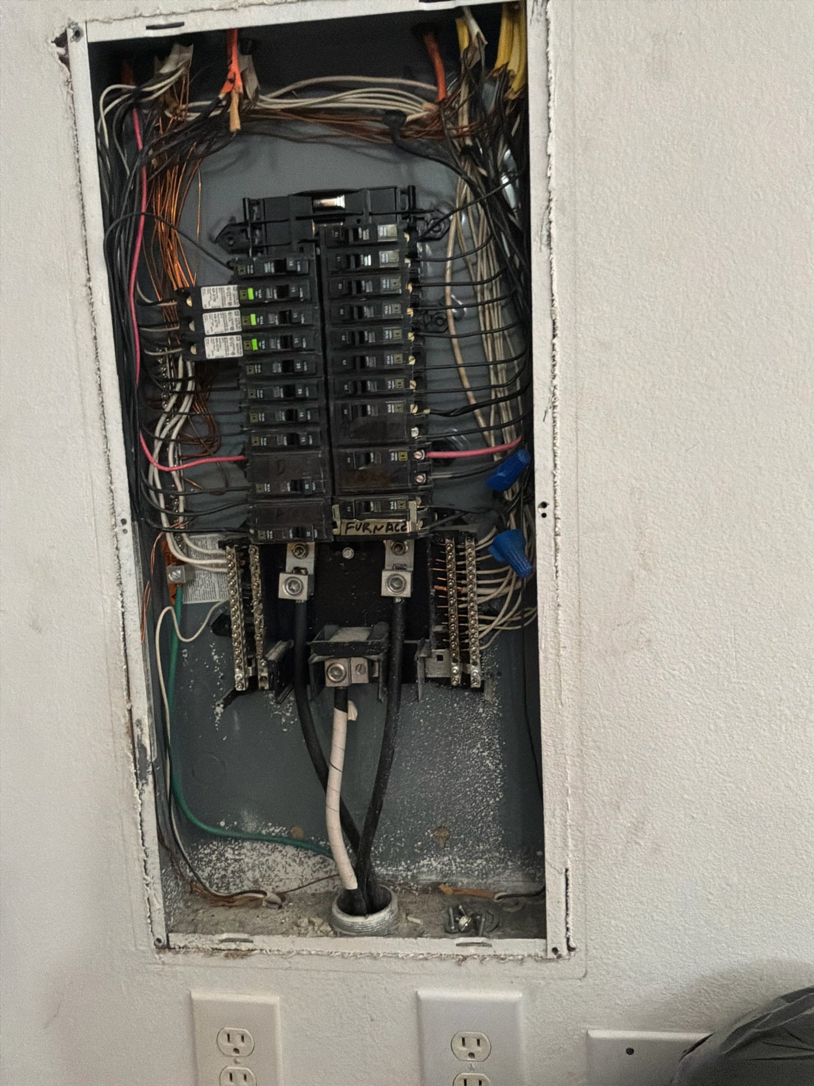Sub-panel showing mixed wiring, backstabbed connections, and non-compliant installation practices.