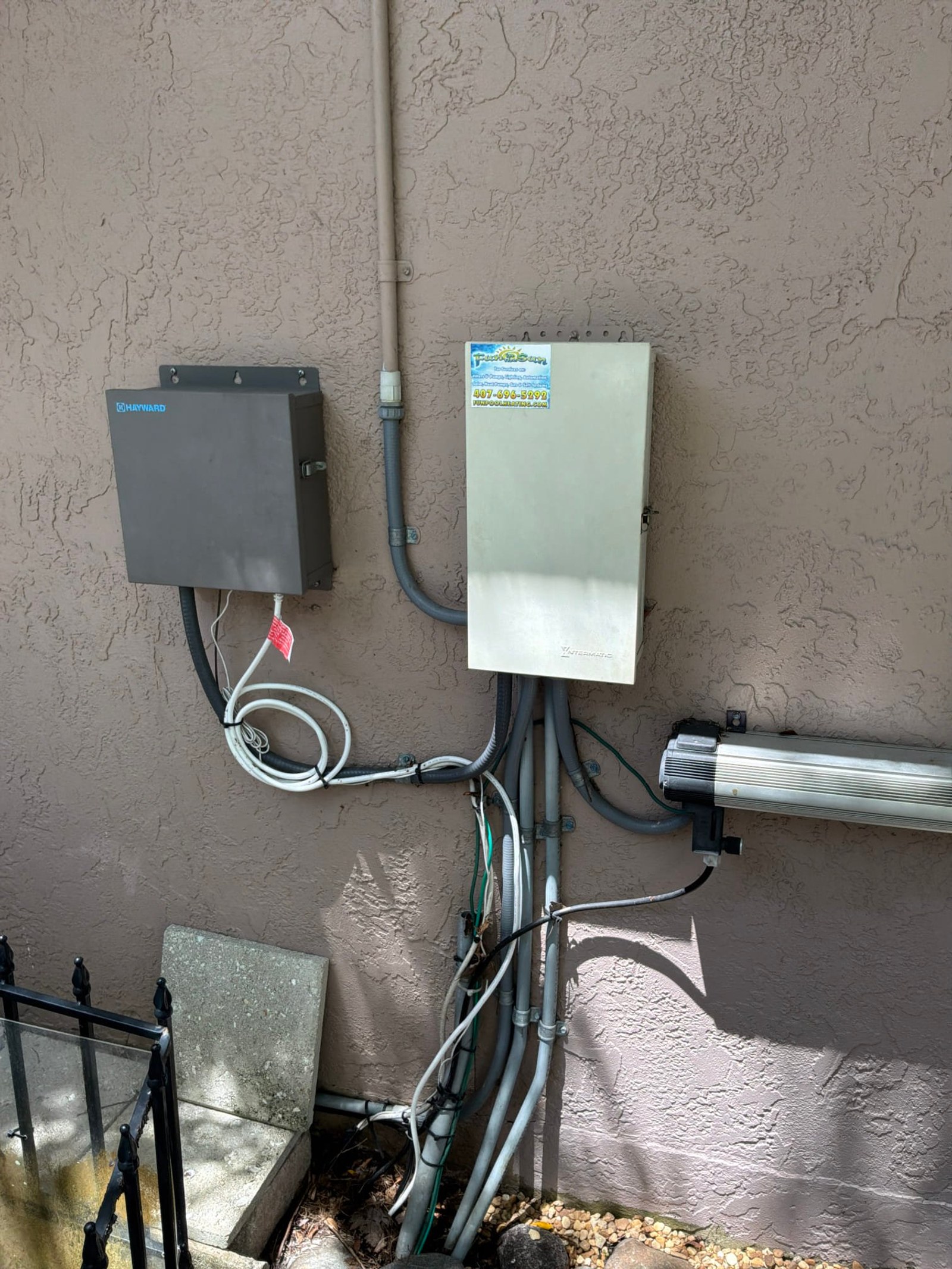 Exterior surge protection equipment installation with Hayward disconnector and new service panel visible.