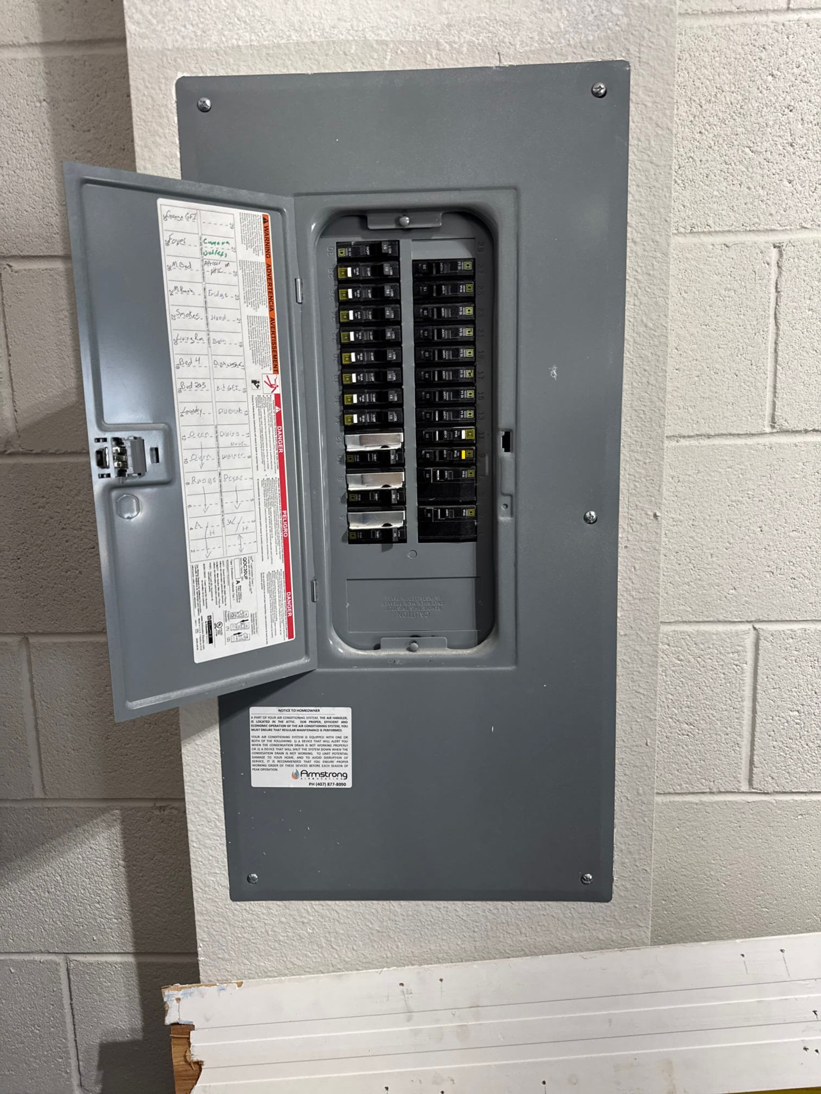 The electrical panel with its dead front in place documented before the work on a Pool Wiring job in Oviedo, FL.