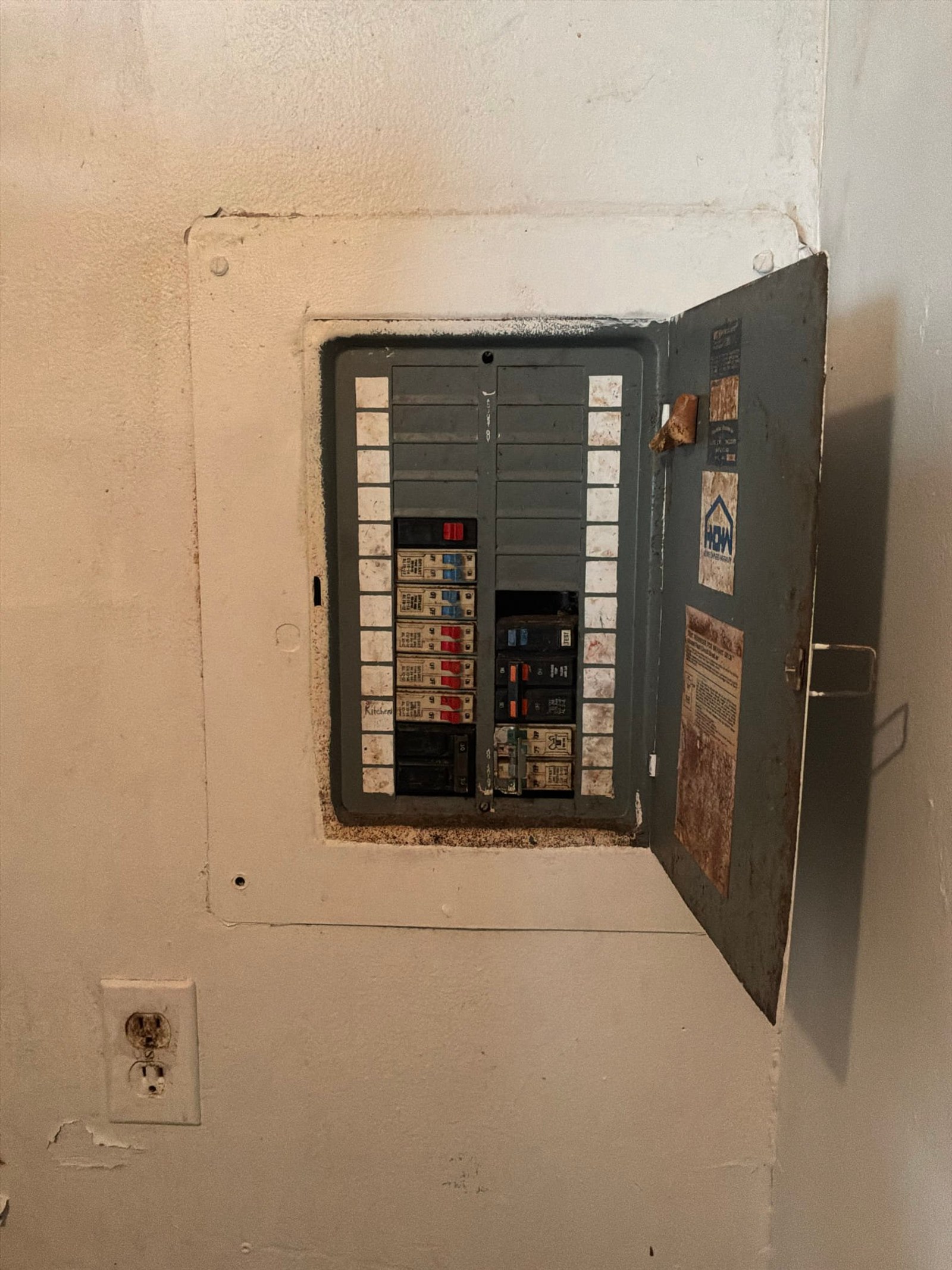 The original electrical panel documented before the work on an Electrical Panel Replacement job in Orlando, FL.